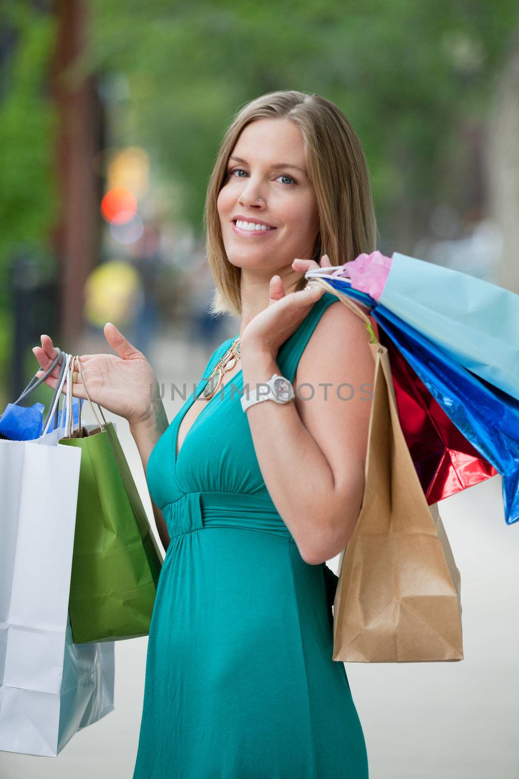 Portrait of beautiful young woman carrying shopping bags
