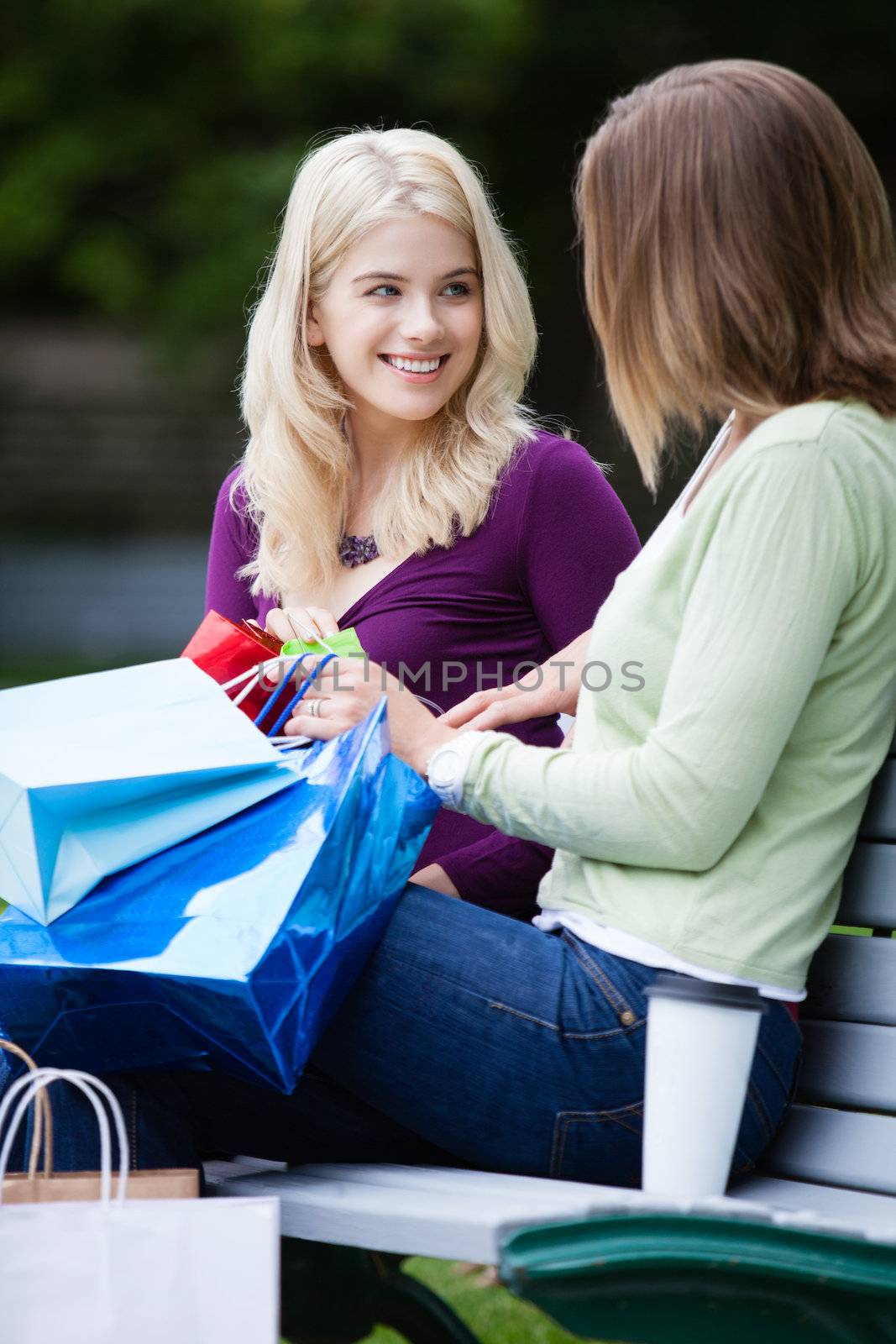 Shopping Women with Takeaway Coffee on bench.