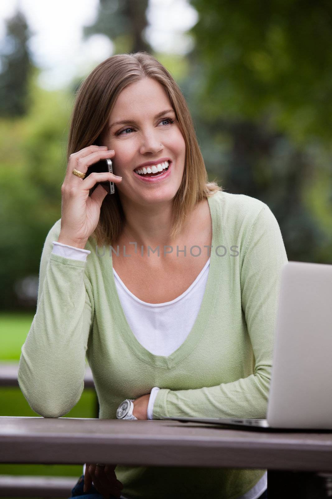 Attractive Woman Talking on Cell Phone by leaf