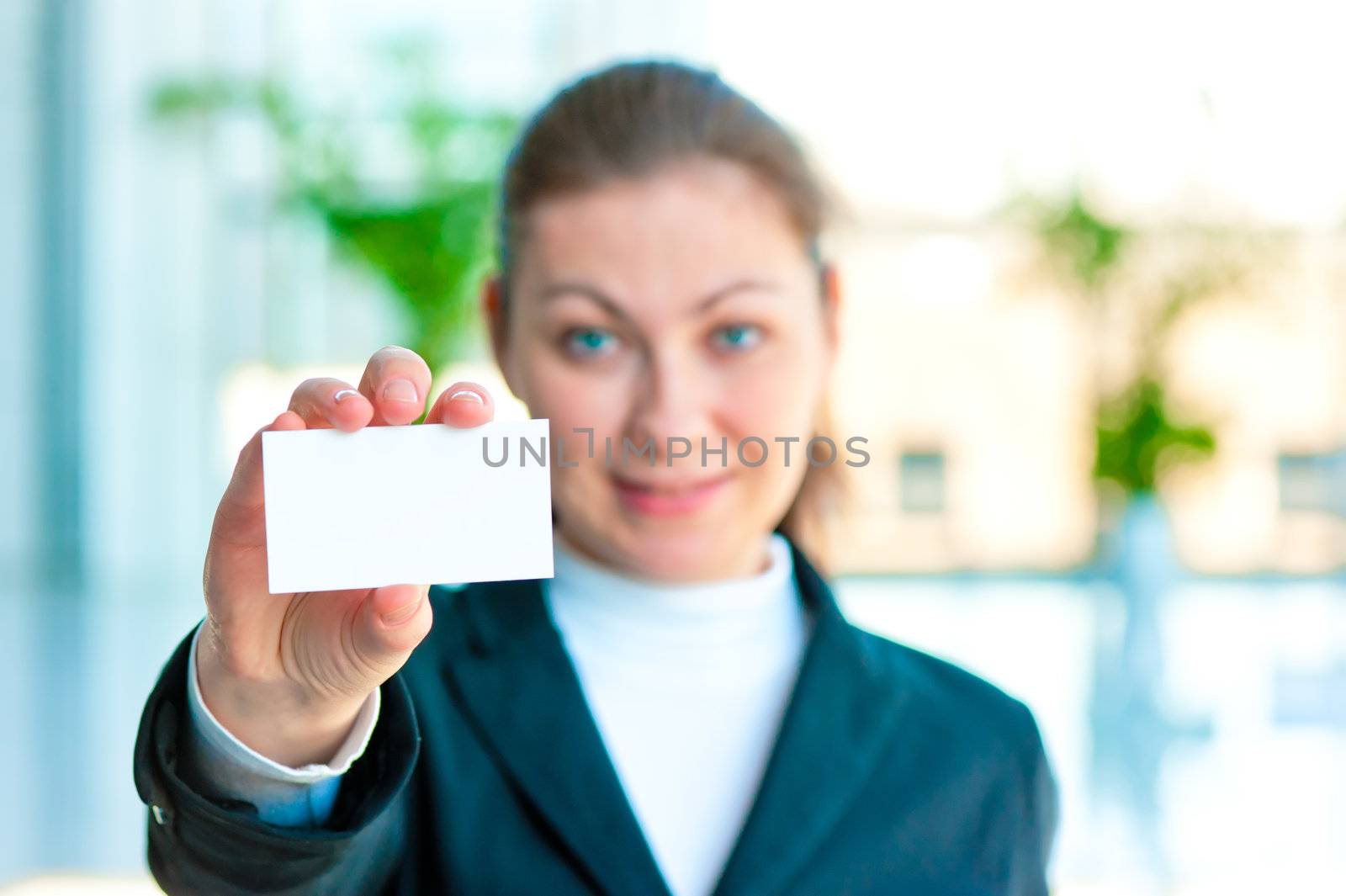 Happy brunette shows a blank business card by kosmsos111