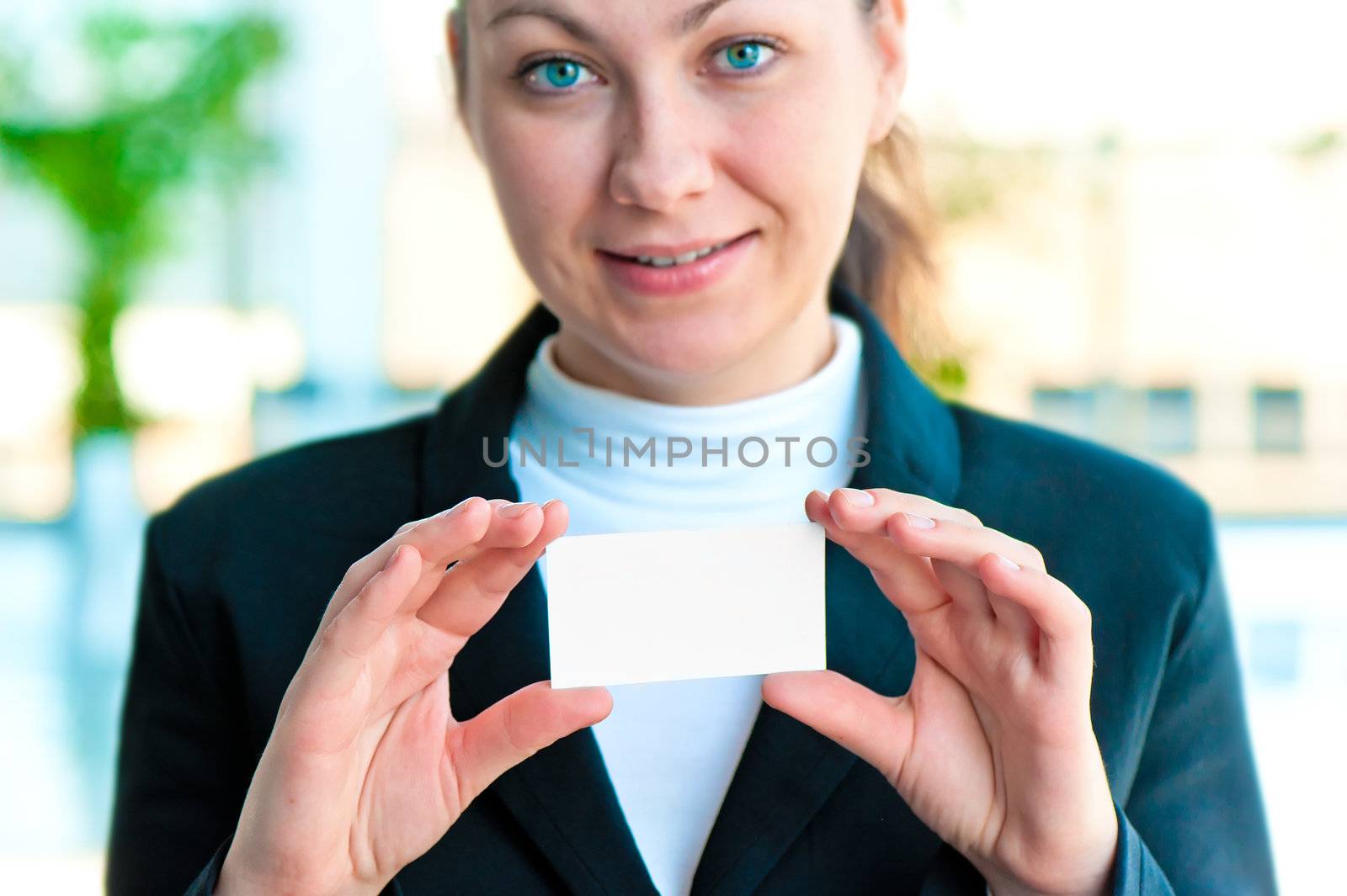 The smiling girl the manager holds the empty business card before herself by kosmsos111