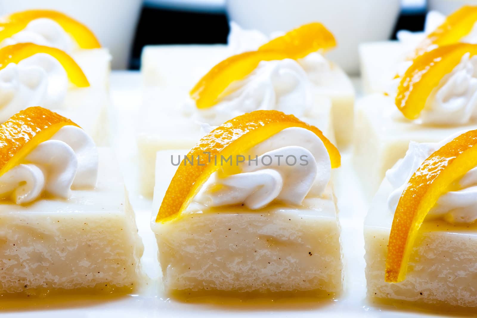 White dessert garnished with whipped cream and zest