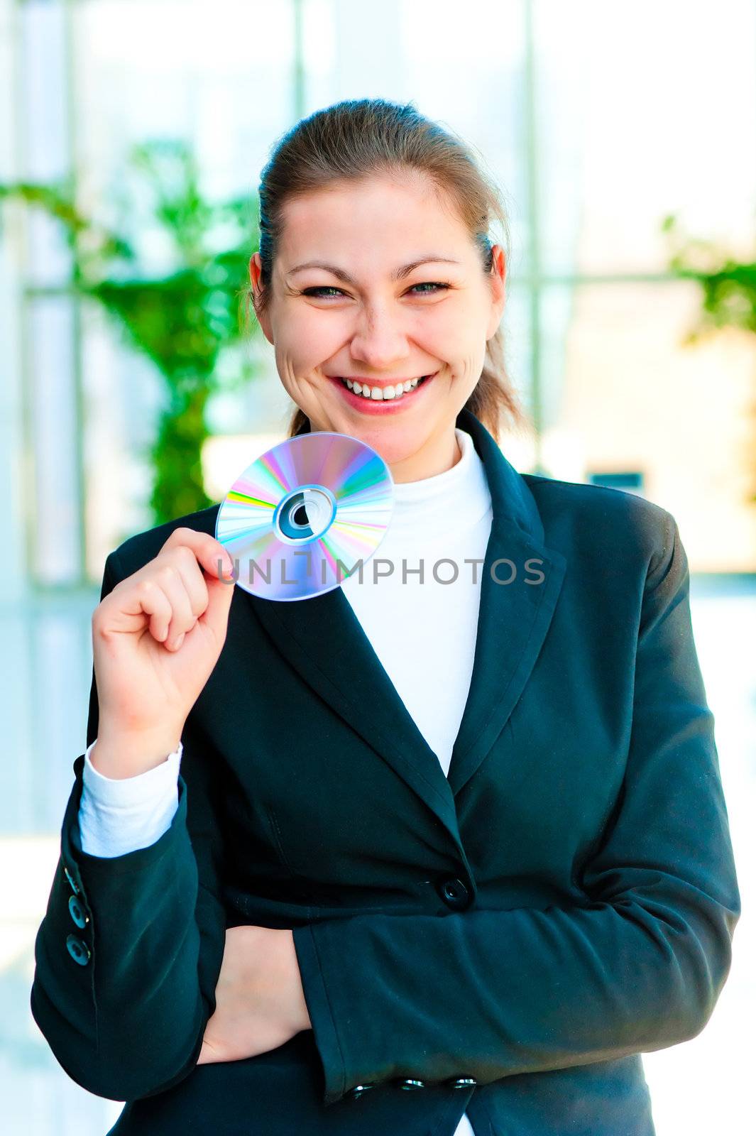 Young happy business woman holding compact disc
