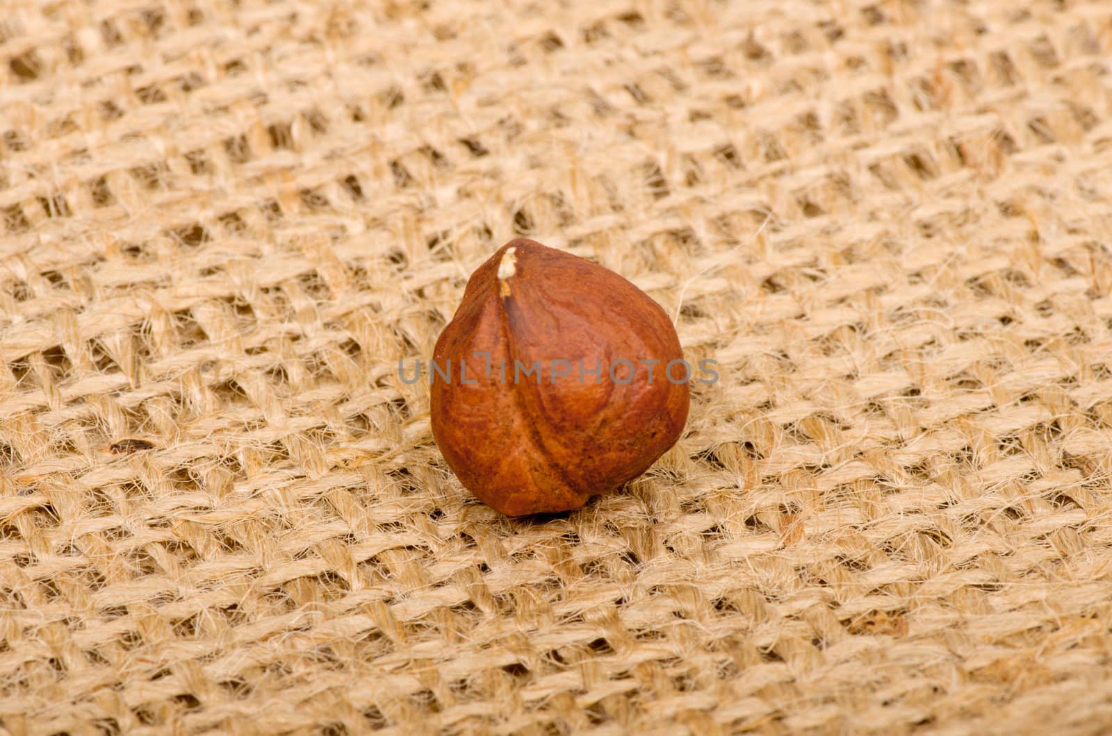 Hazelnuts on burlap background