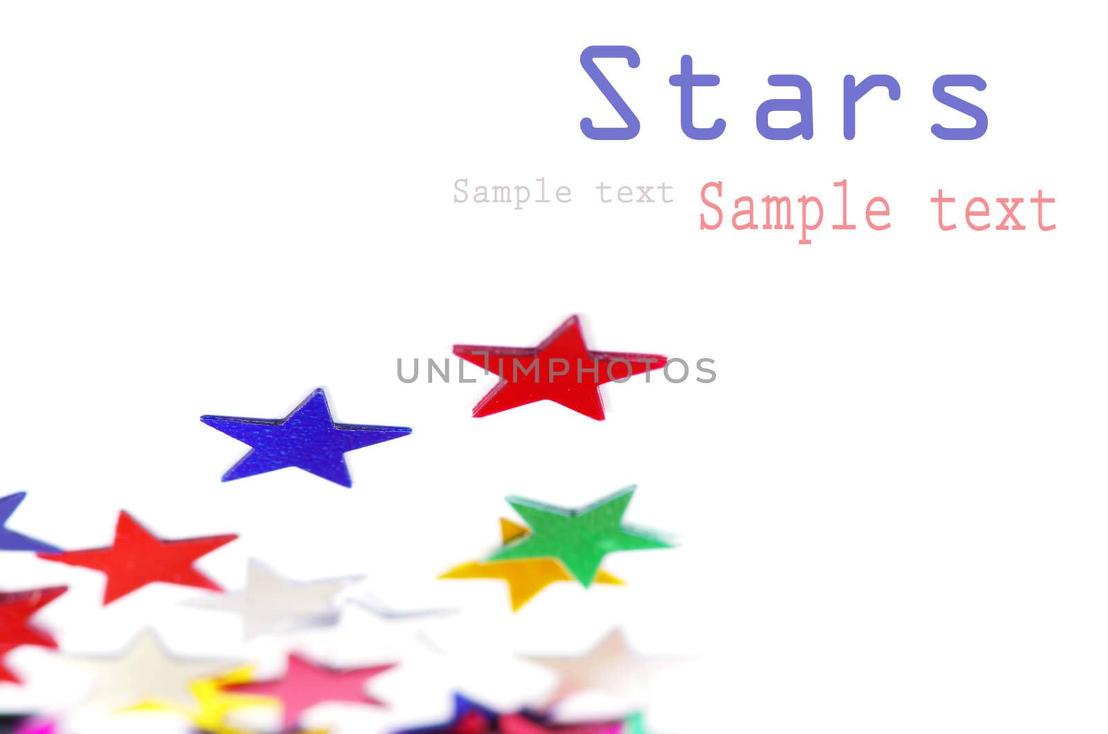 Christmas decoration of colored confetti stars against white background