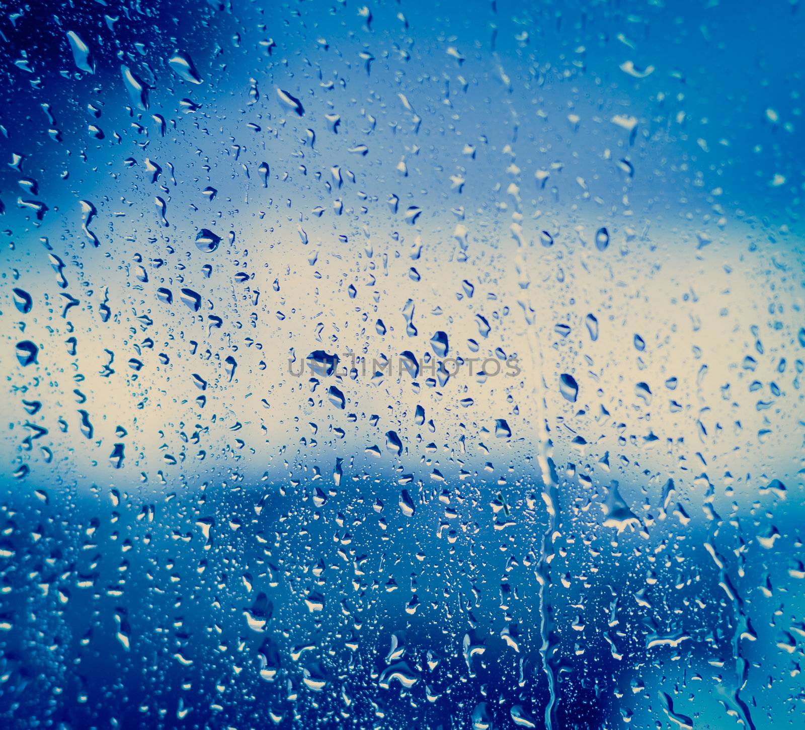 Drops Of Rain On Blue Glass Background