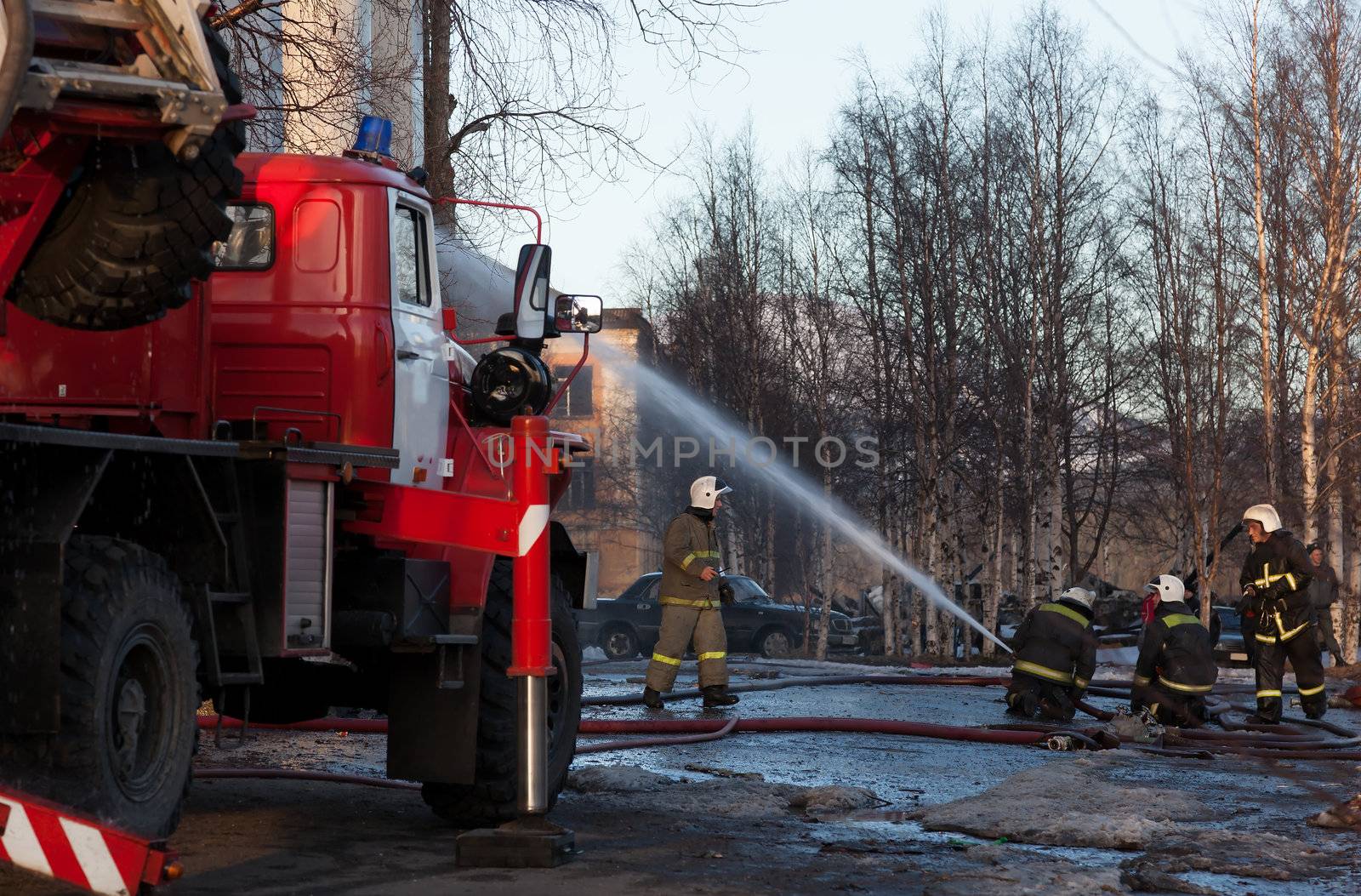 Firefighters extinguish a fire by AleksandrN