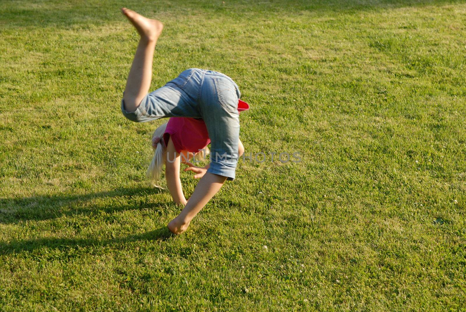 Girl doing gymnastics in the garden. Please note: No negative use allowed