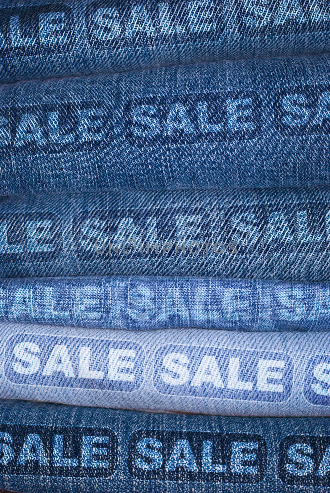 Sale Signs on Stack of Blue Jeans