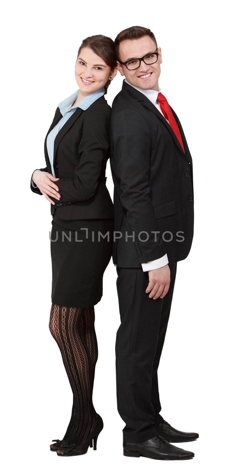 Young happy business couple standing back on back isolated against a white background.