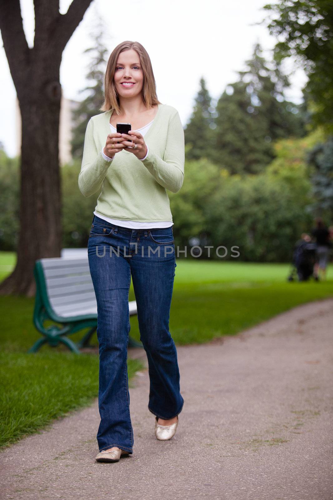 Woman Using Cell Phone in park.