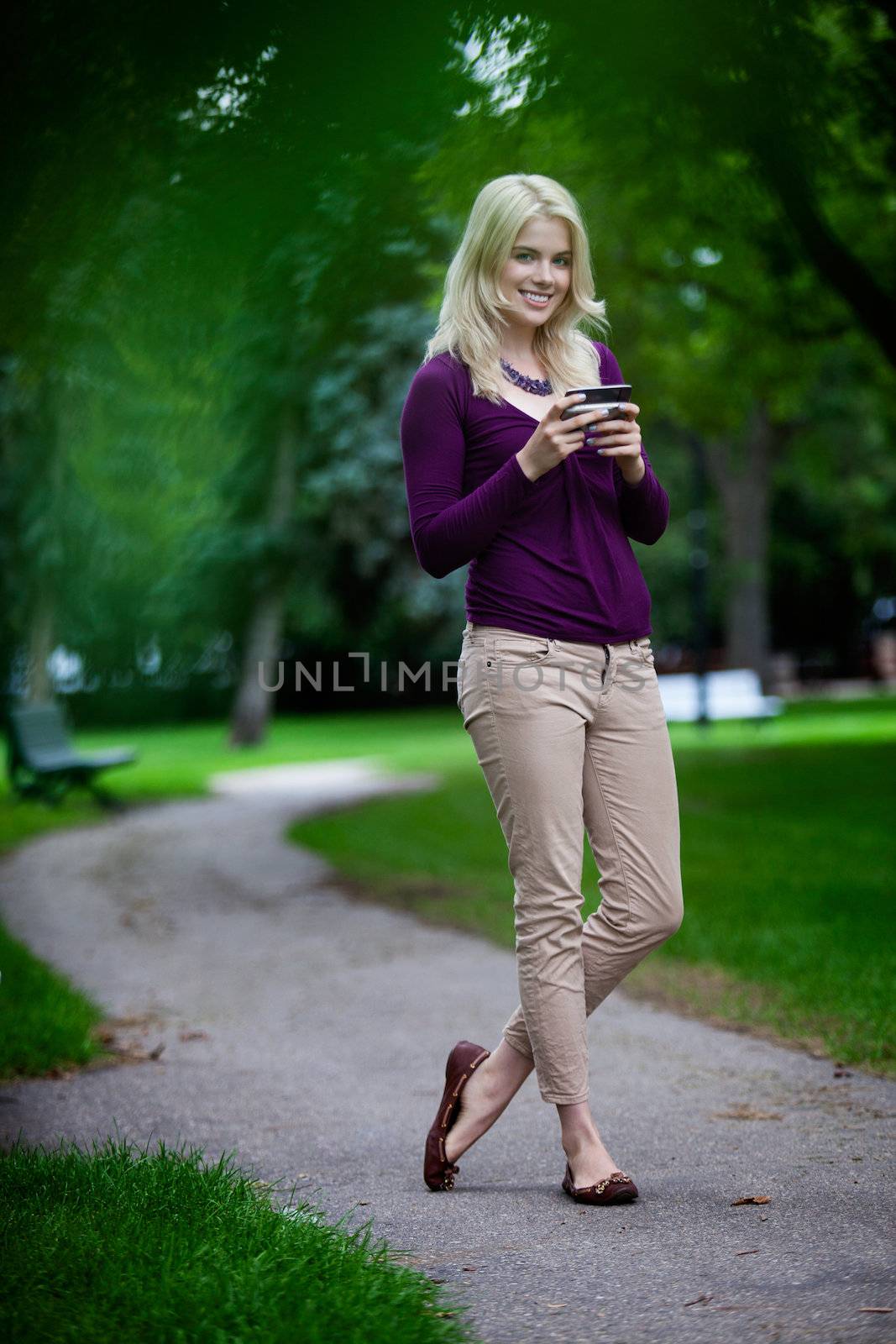 Woman Using Cell Phone by leaf
