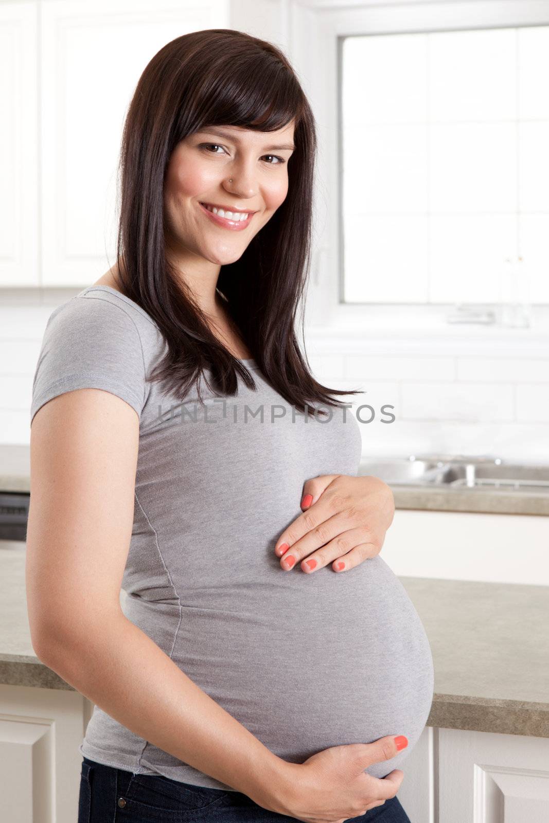Beautiful Pregnant Woman Holding Belly by leaf