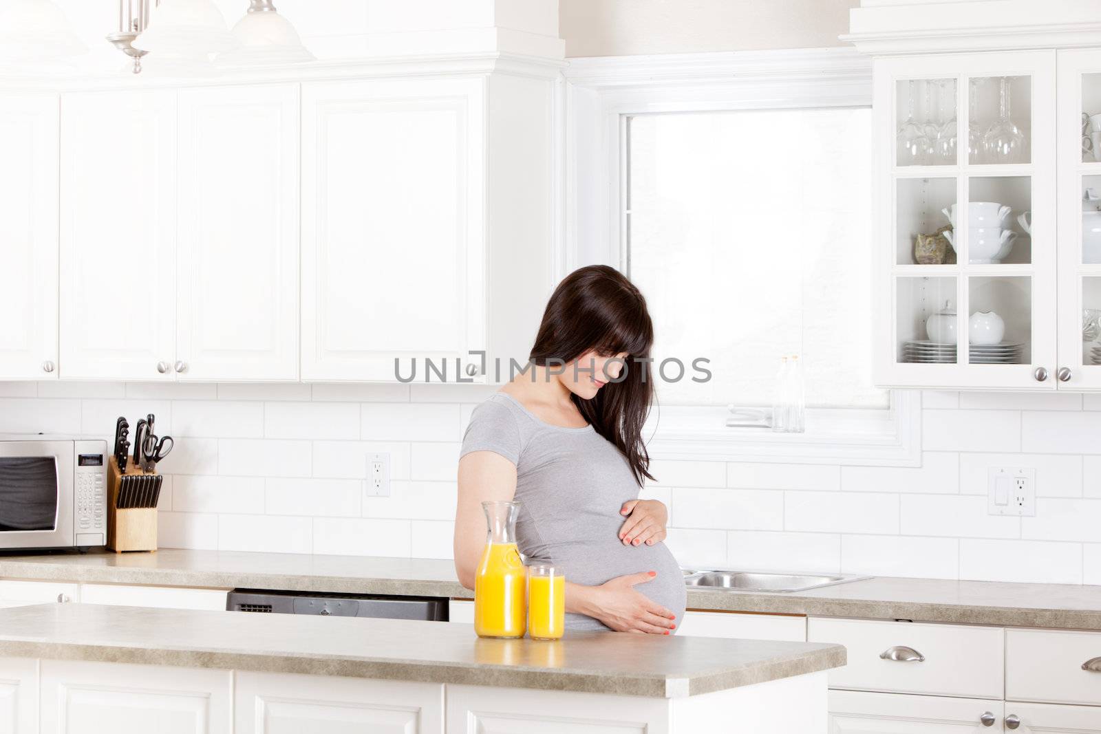 Pregnant Woman Looking at Belly by leaf