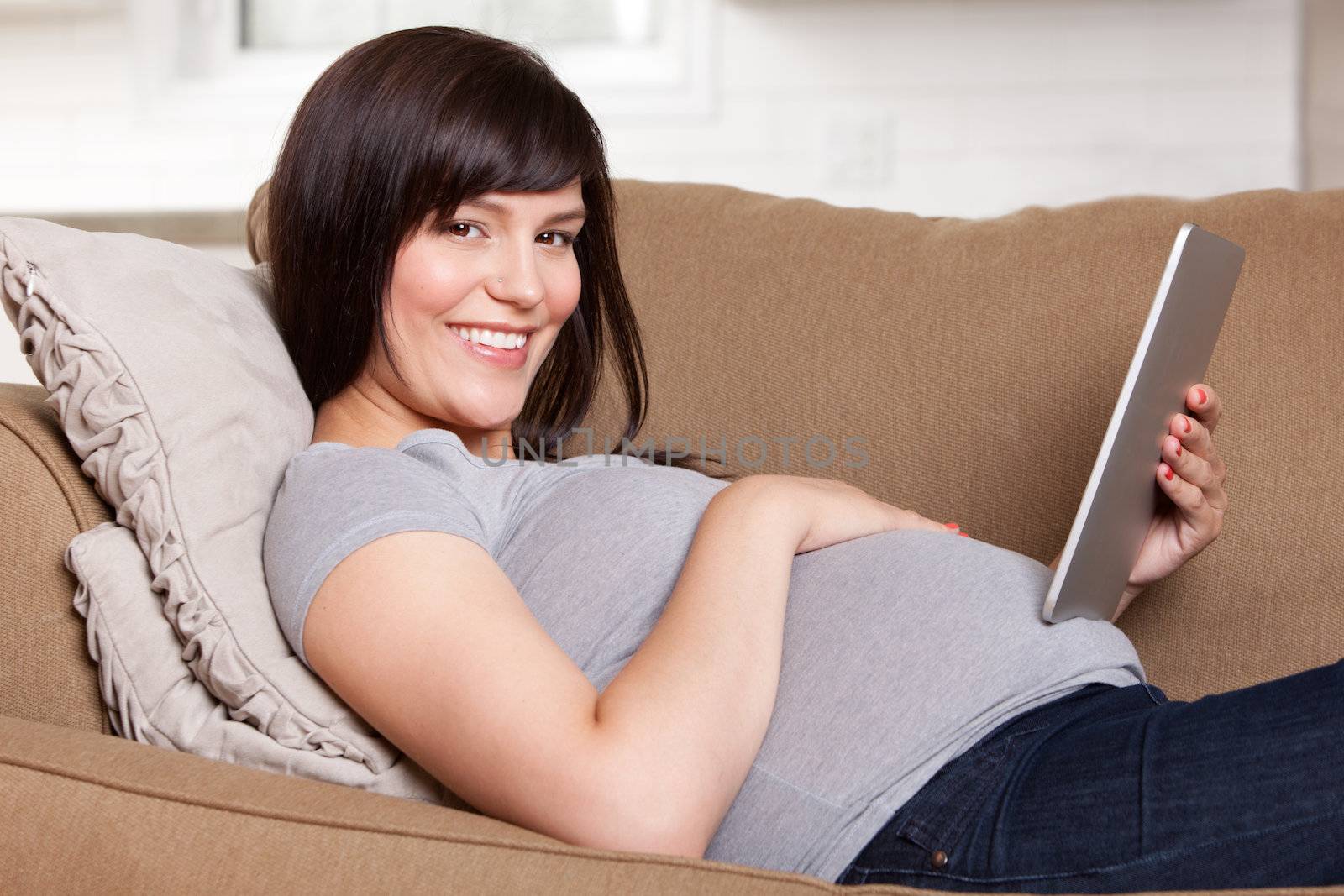 Pregnant Woman Using Digital Tablet by leaf