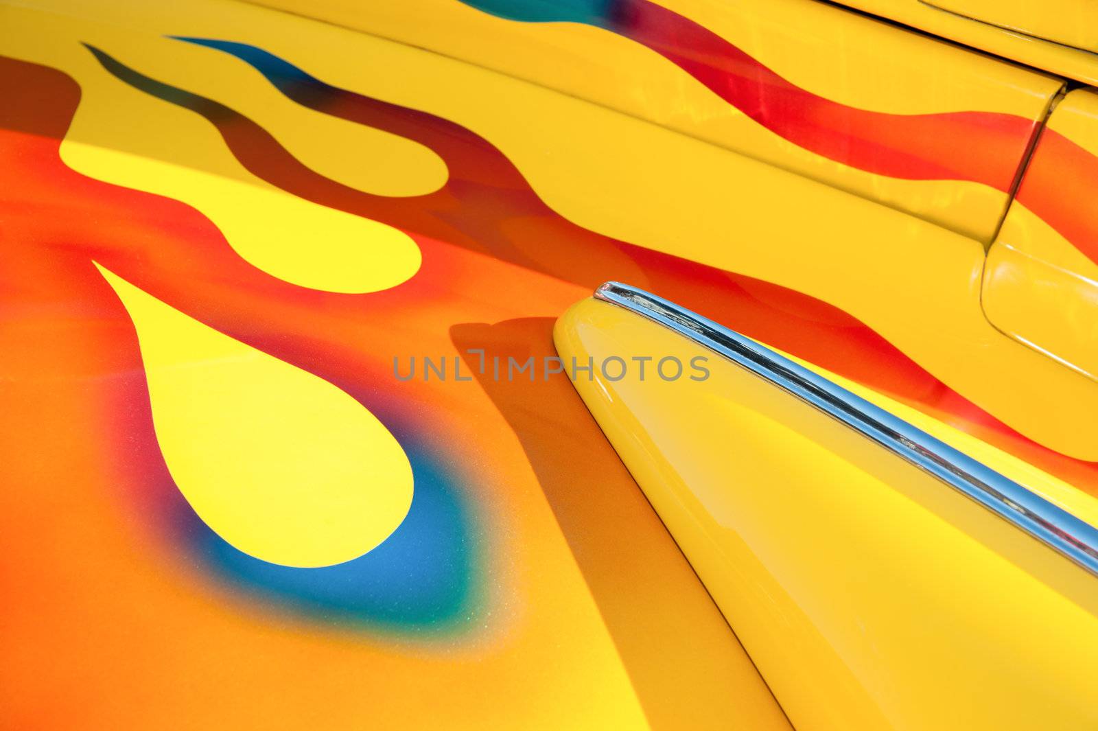 vehicle panel abstract with vivid yellow and flame metallic body paintwork