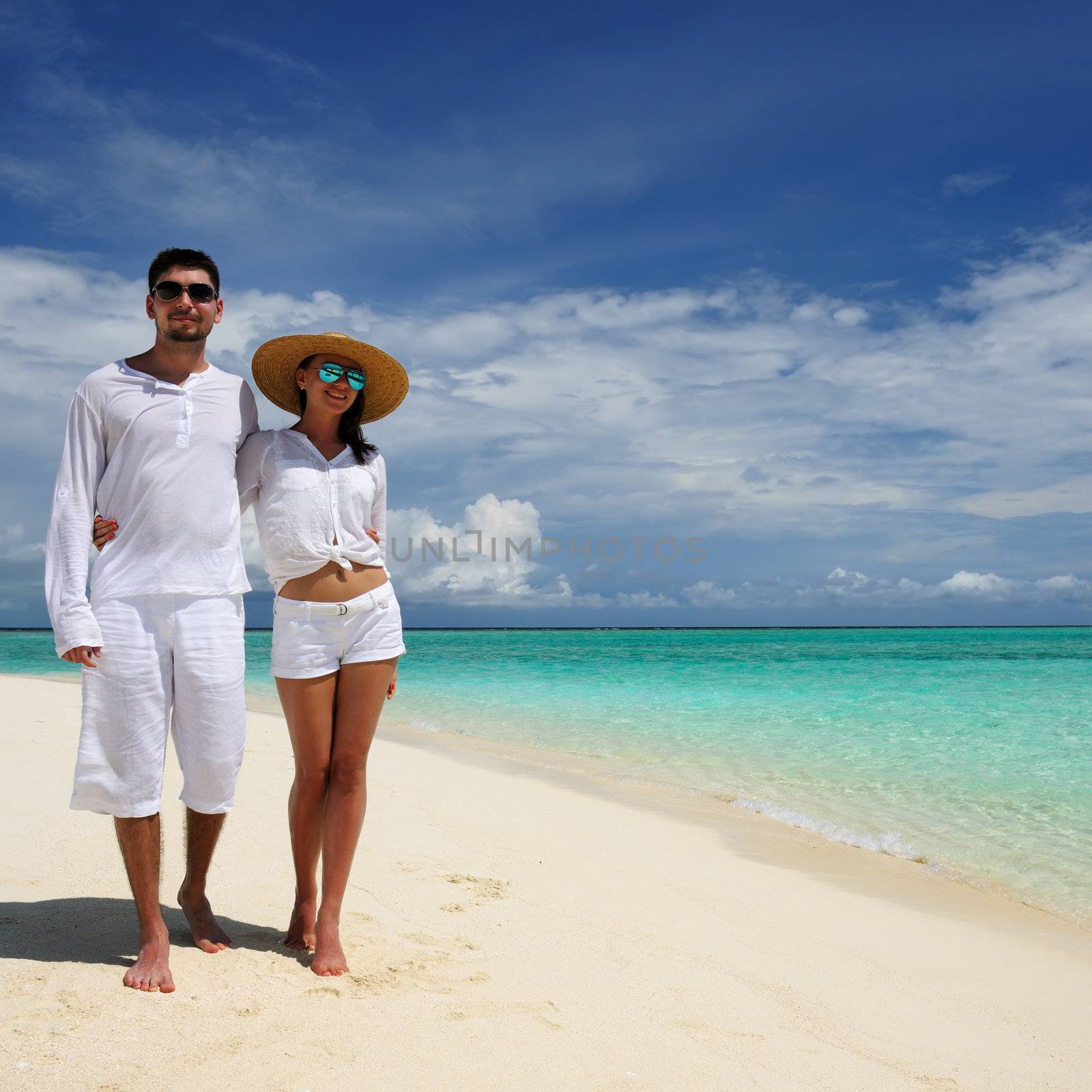 Couple on a beach at Maldives by haveseen