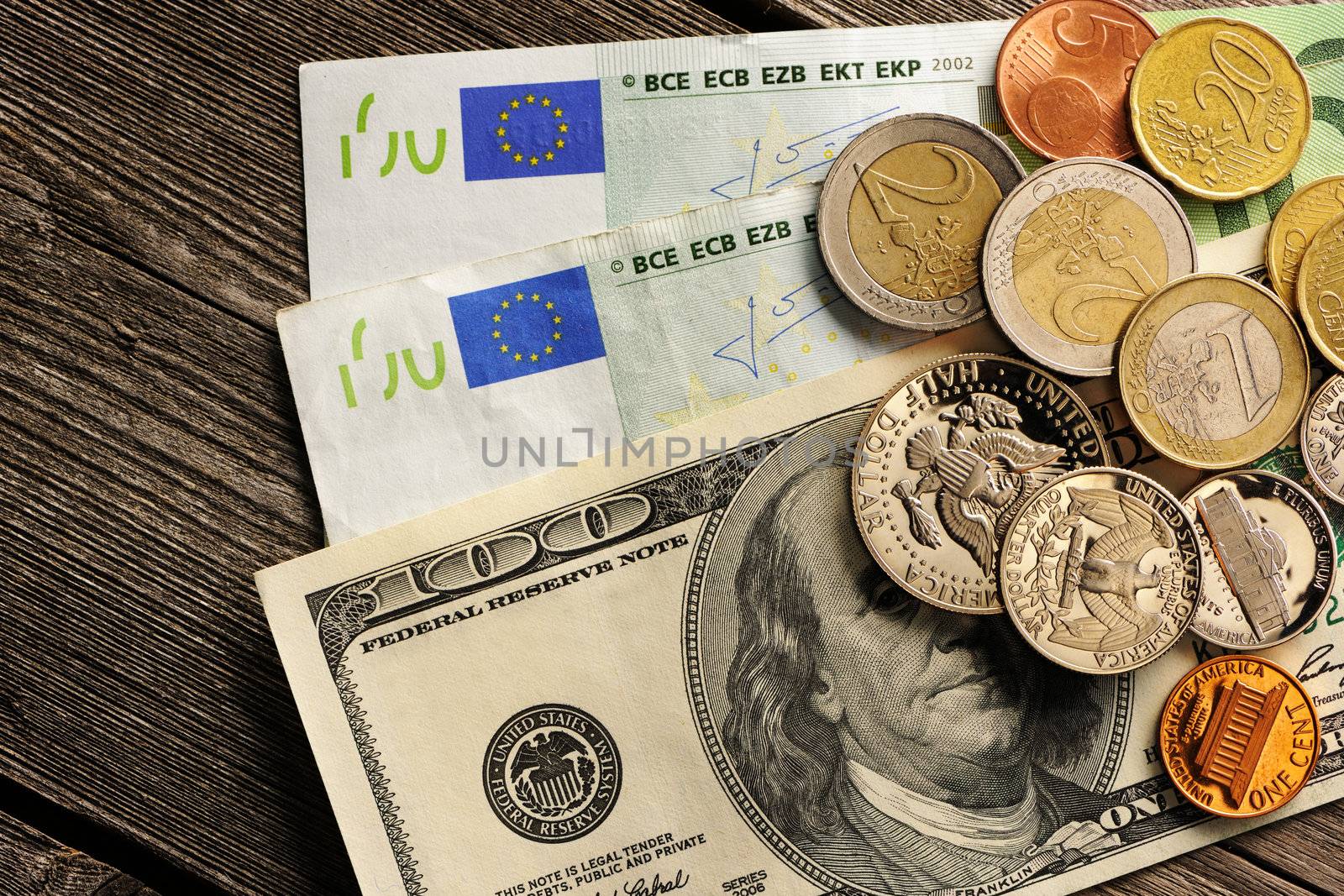 US and euro currency over wooden background
