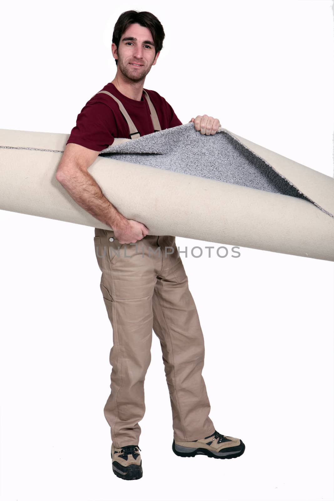 Man carrying rolled carpet by phovoir