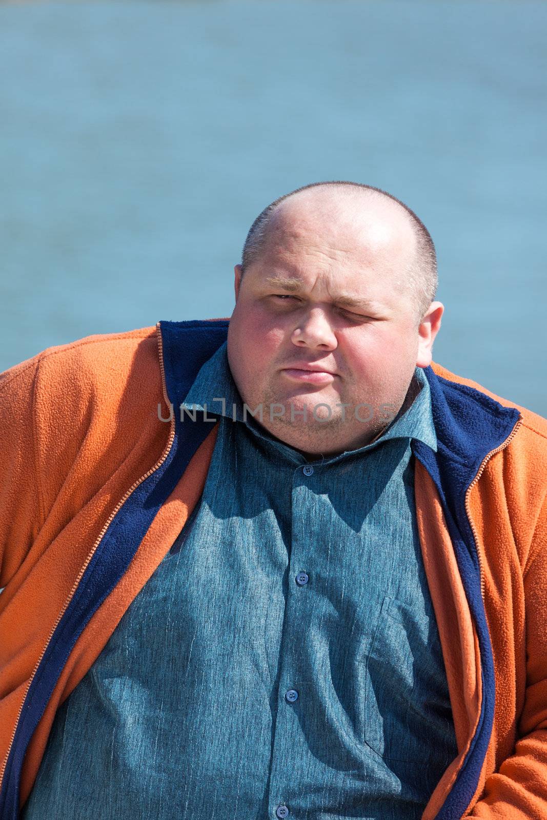 Portrait of a pretty fat man, on a background of water