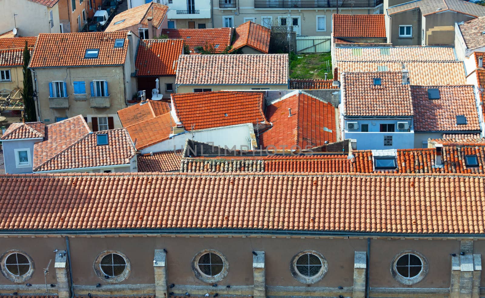 Top view on red tiled roofs, sunny day