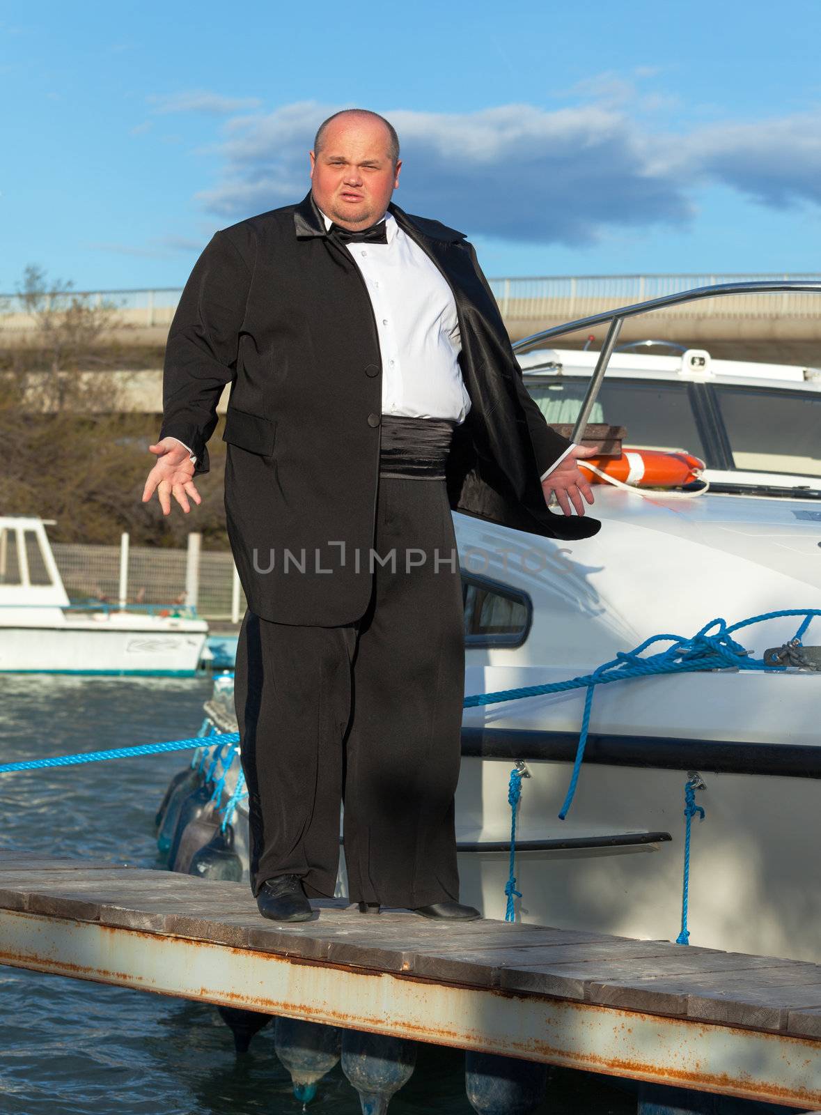 Fat man in tuxedo on deck boat by Discovod