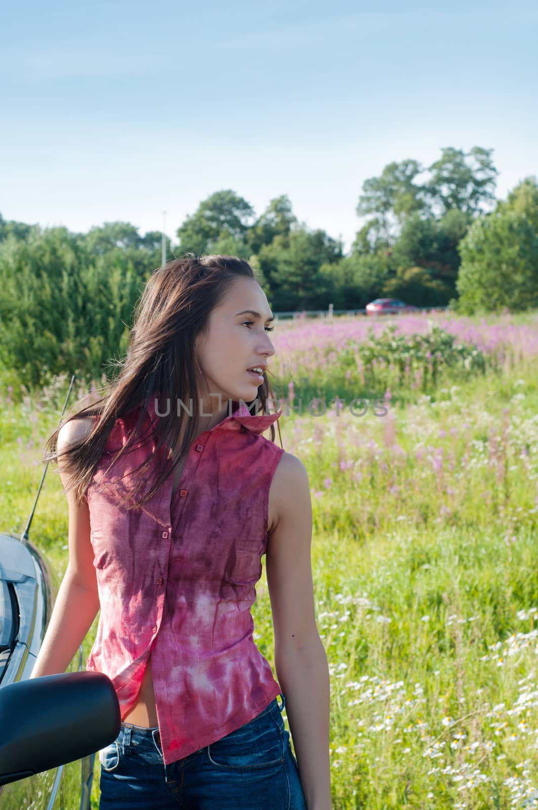 Outdoor shot of beautiful brunette woman with long hair