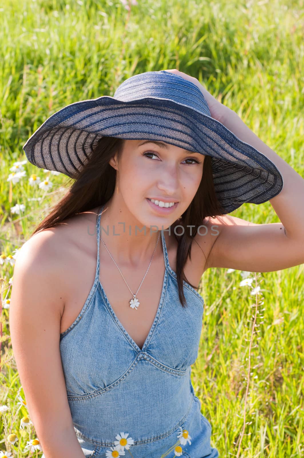 Beautiful brunette woman in big denim hat by anytka