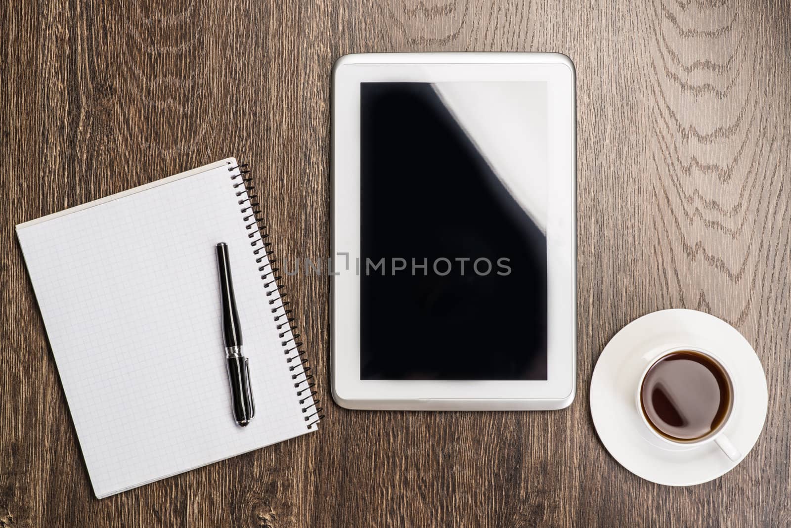 pen, coffee and tablet on the table, workplace businessman