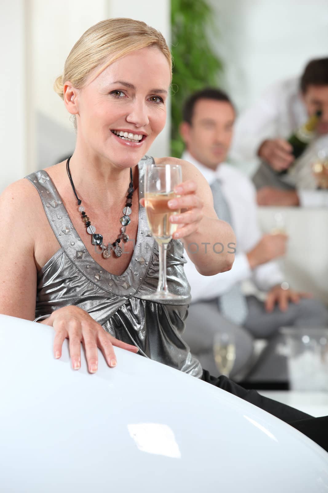Woman with glass of champagne by phovoir