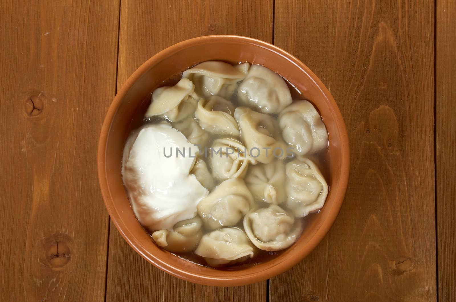 Traditional Russian food "pelmeni".Meat dumplings  with sour cream