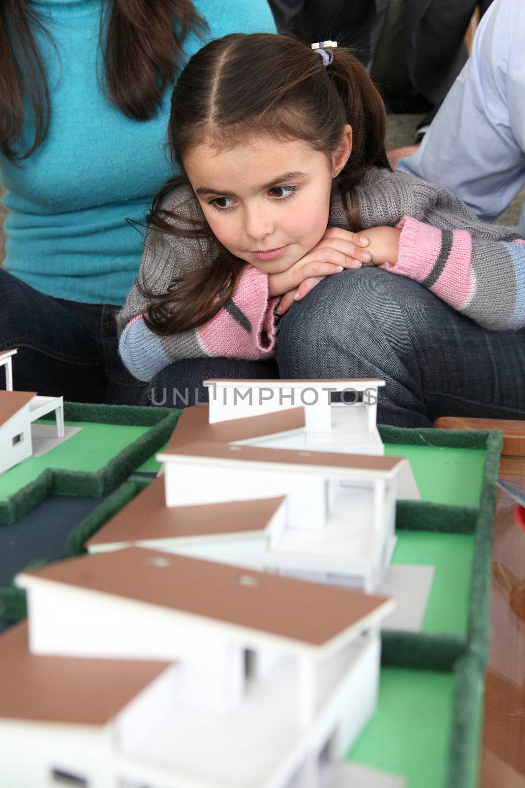 Young family sat with scale model of new home by phovoir