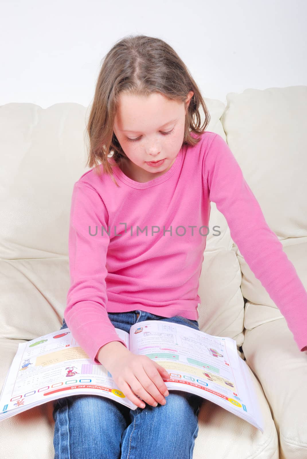 Girl student on the couch with a notebook