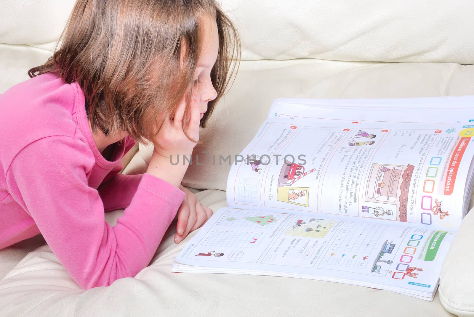 Girl student on the couch with a notebook