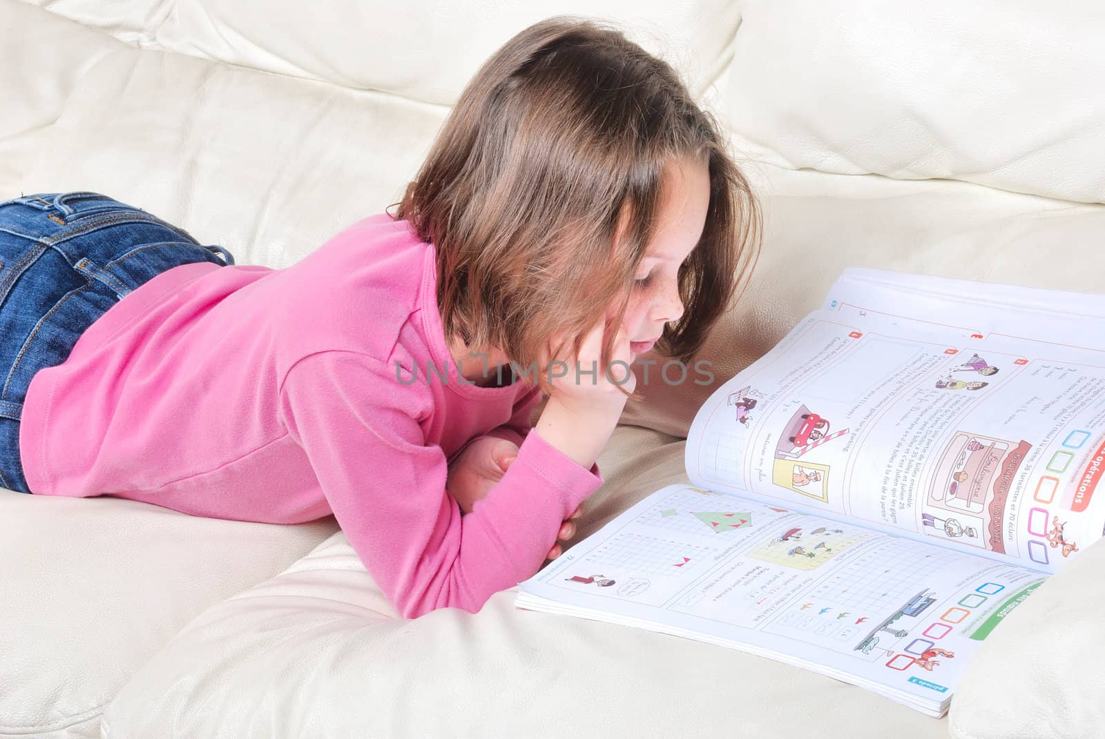 Girl student on the couch with a notebook