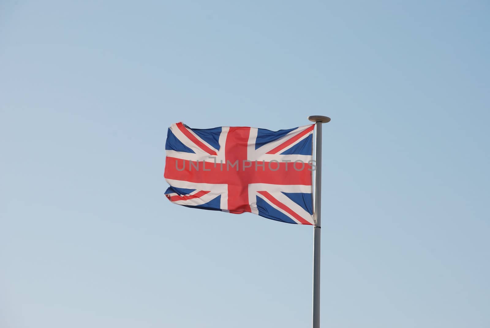 Union Jack British flag flying on a weathered flag pole