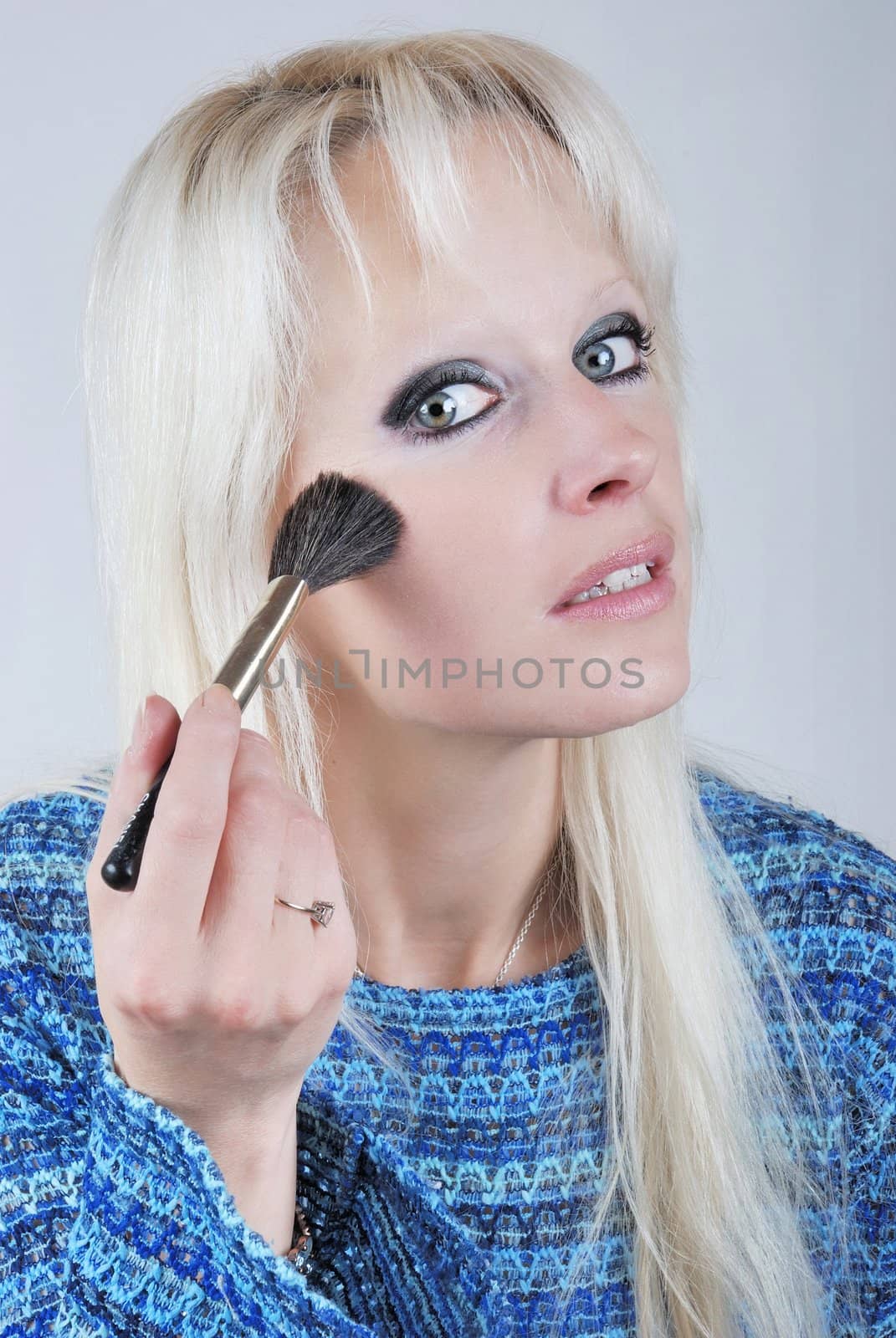  Woman applying makeup