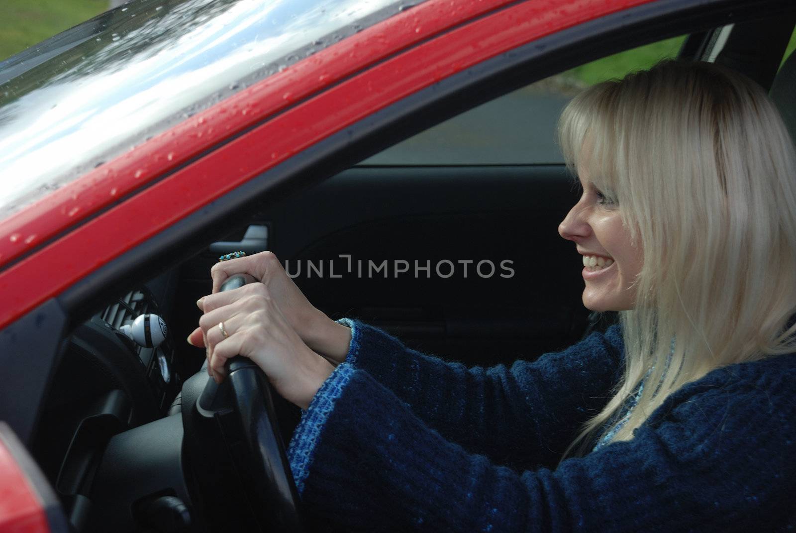 woman driving a red car