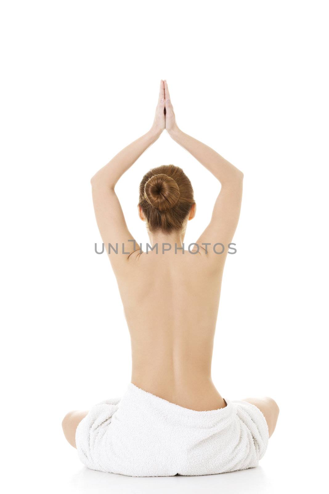 Young beautiful nude woman with towel practicing zoga , isolated on white