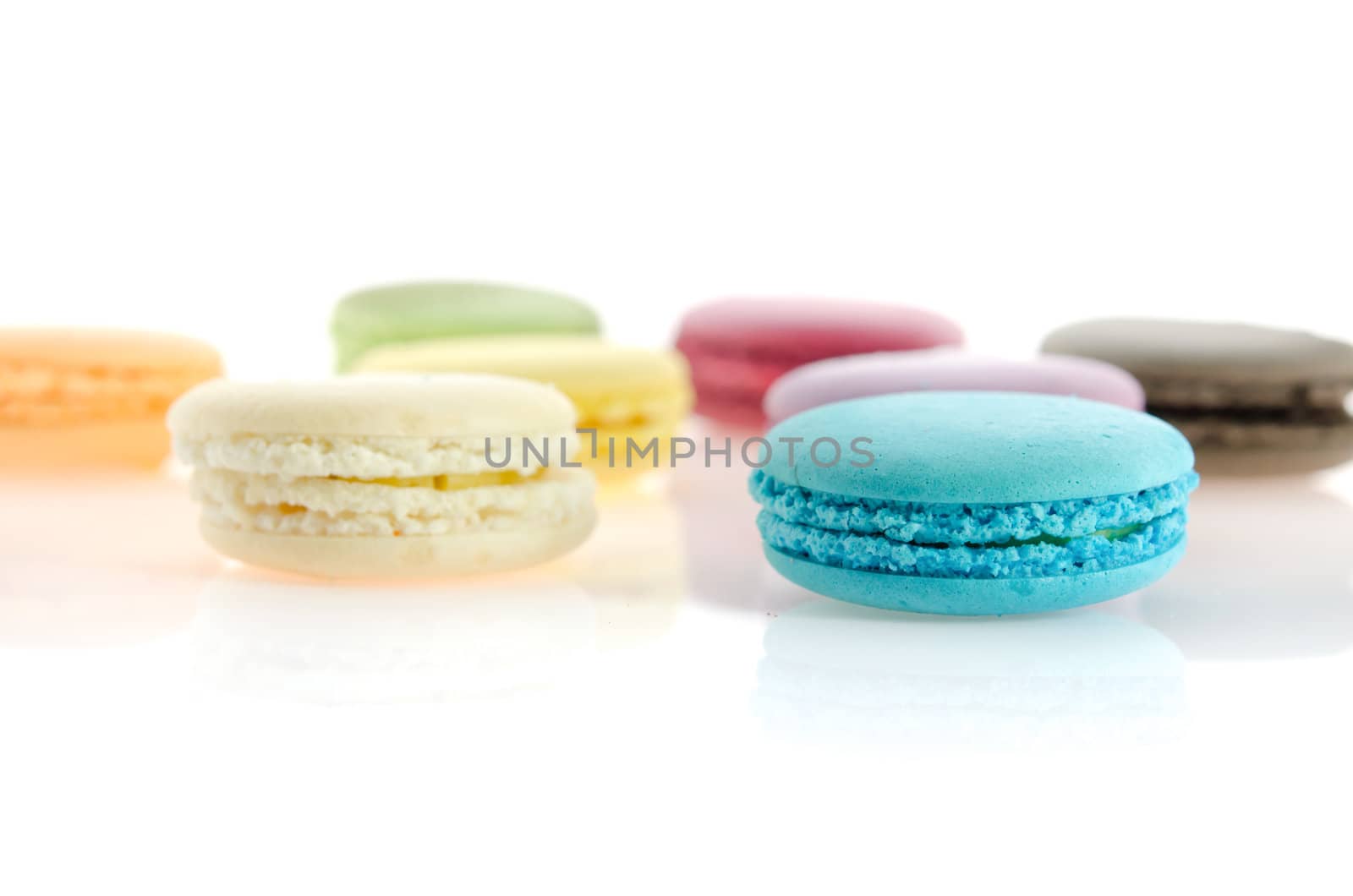 colorful of  french macaroons  over  white with reflection