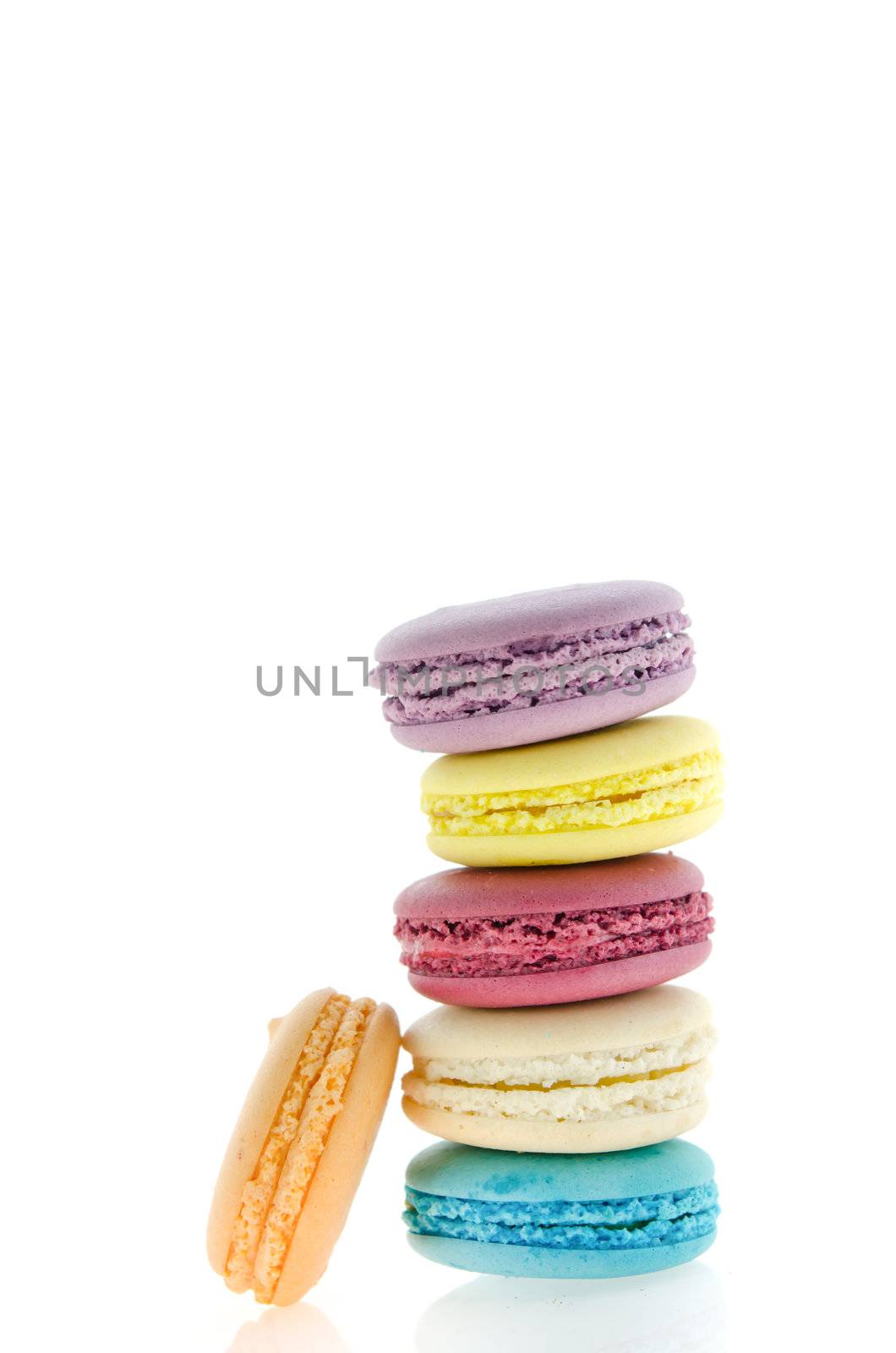 colorful  french macaroons  stack on  white background with reflection