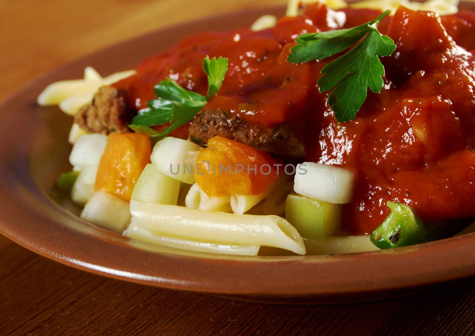  pasta with tomato beef sauce  on wooden table