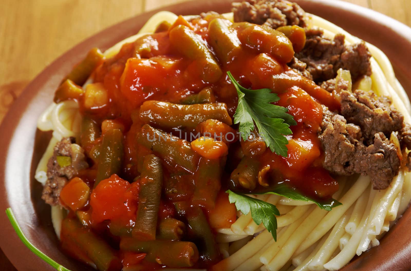  pasta with  beef ,vegetable  tomato sauce  on wooden table