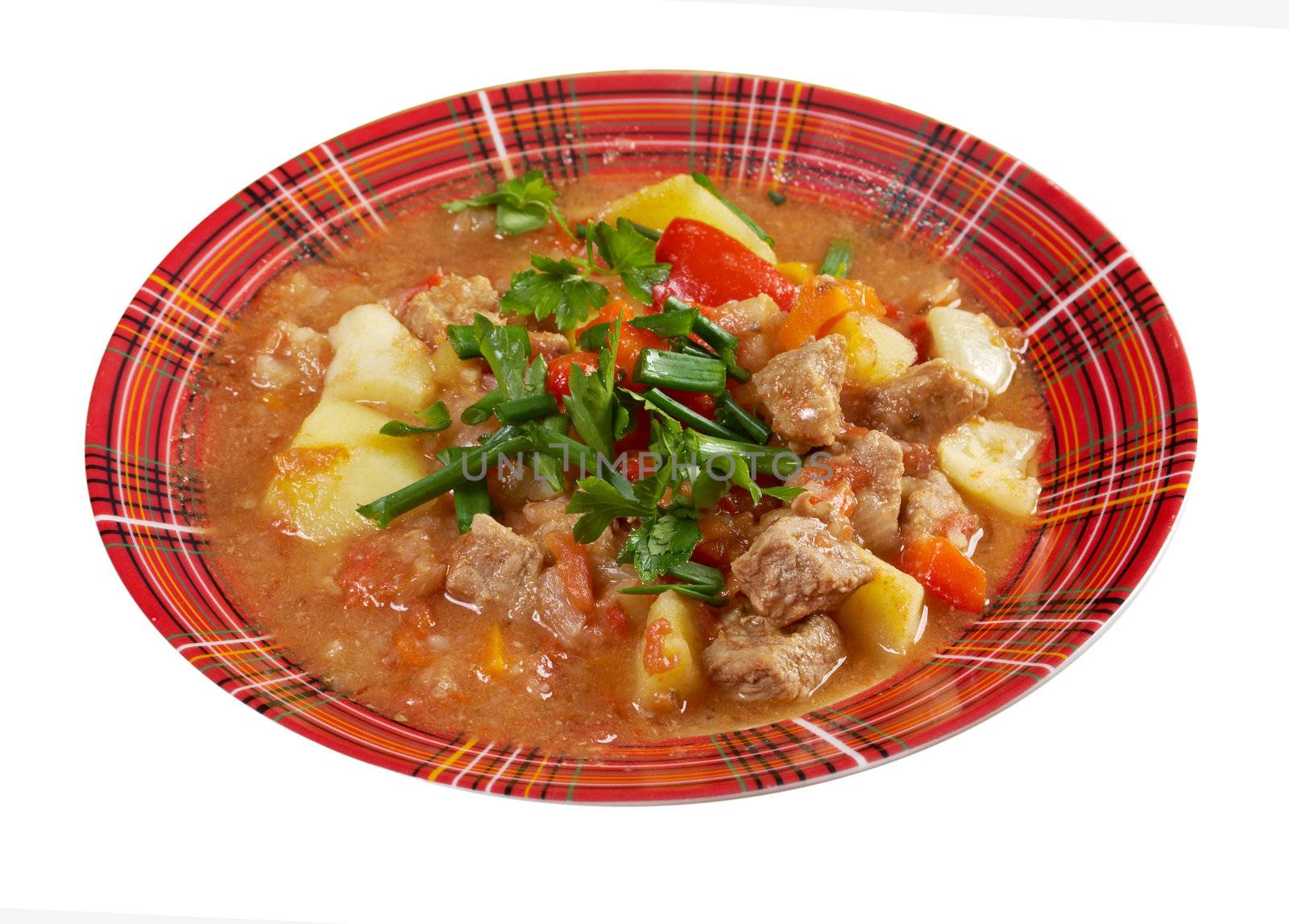 Traditional Hungarian homemade hot goulash soup.isolated on white background. 