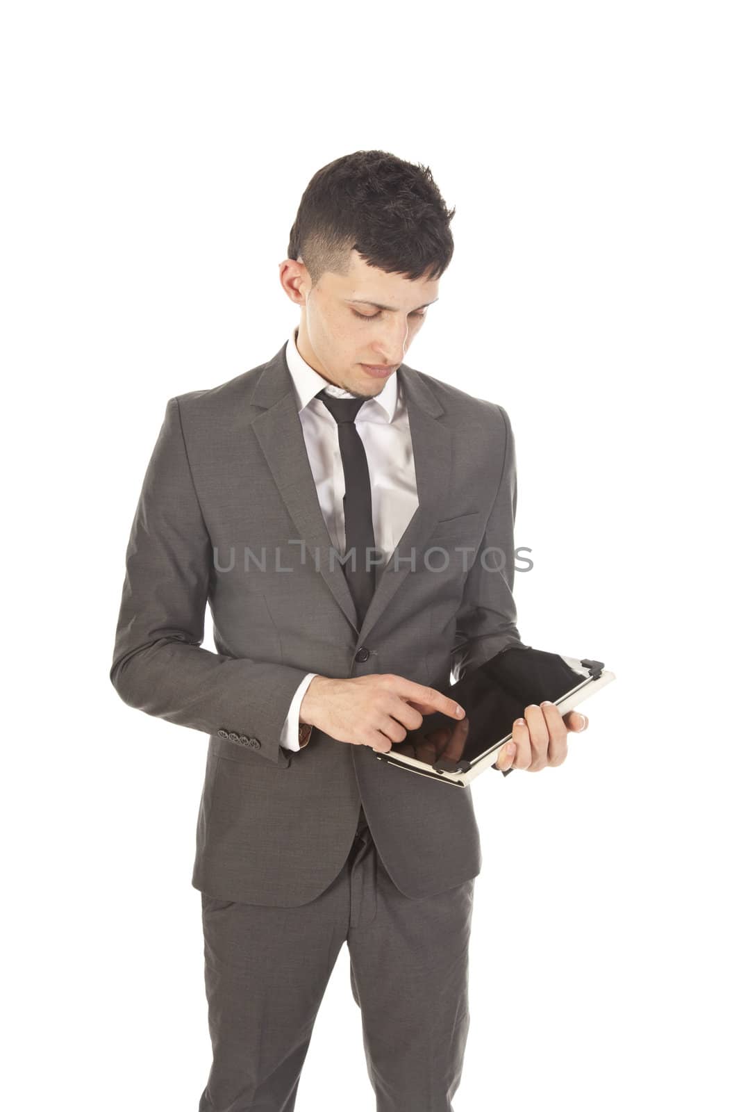 Young man holding a black tablet isolated on white