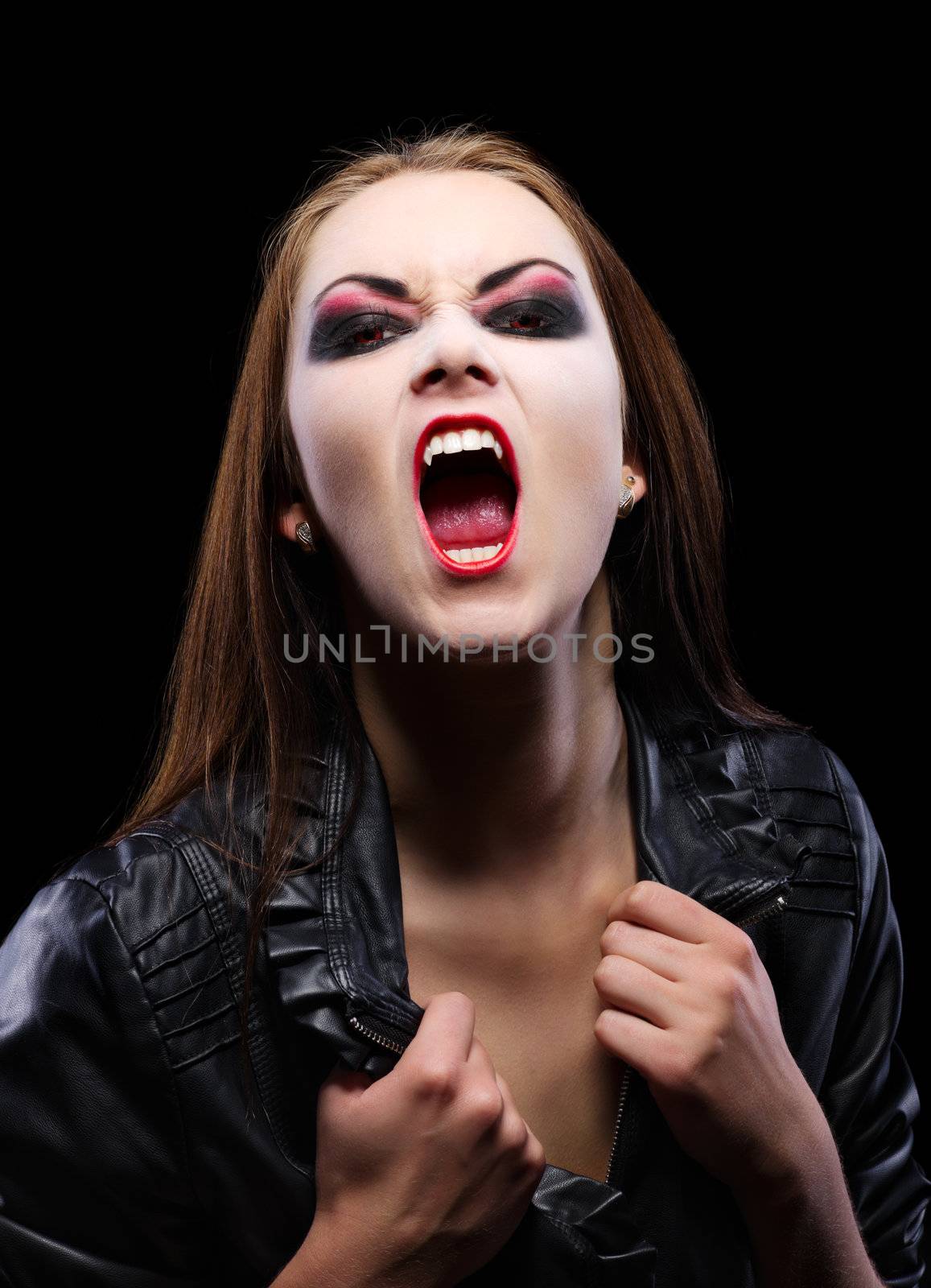 Young beautiful vampire woman on black