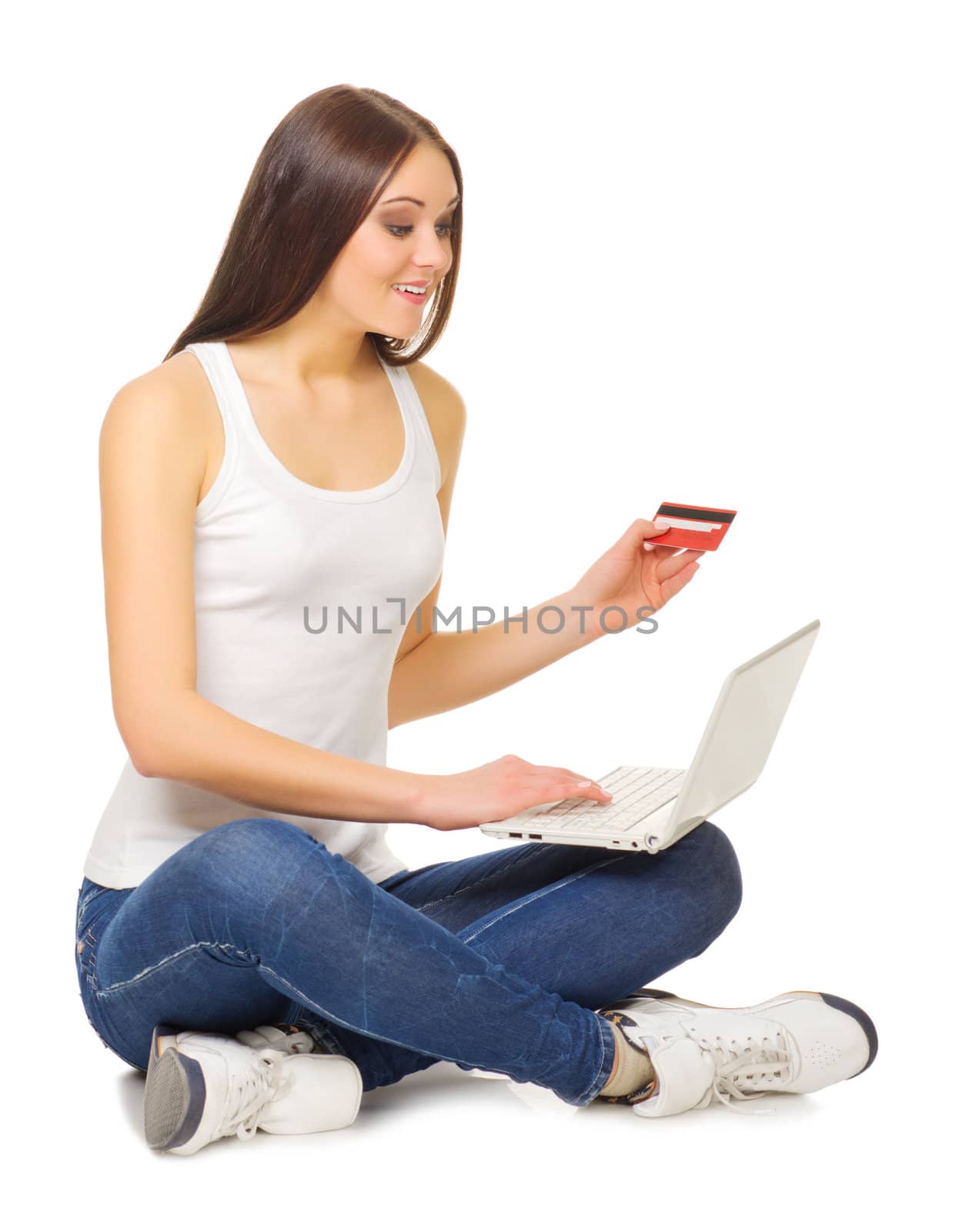 Young girl with laptop and credit card isolated