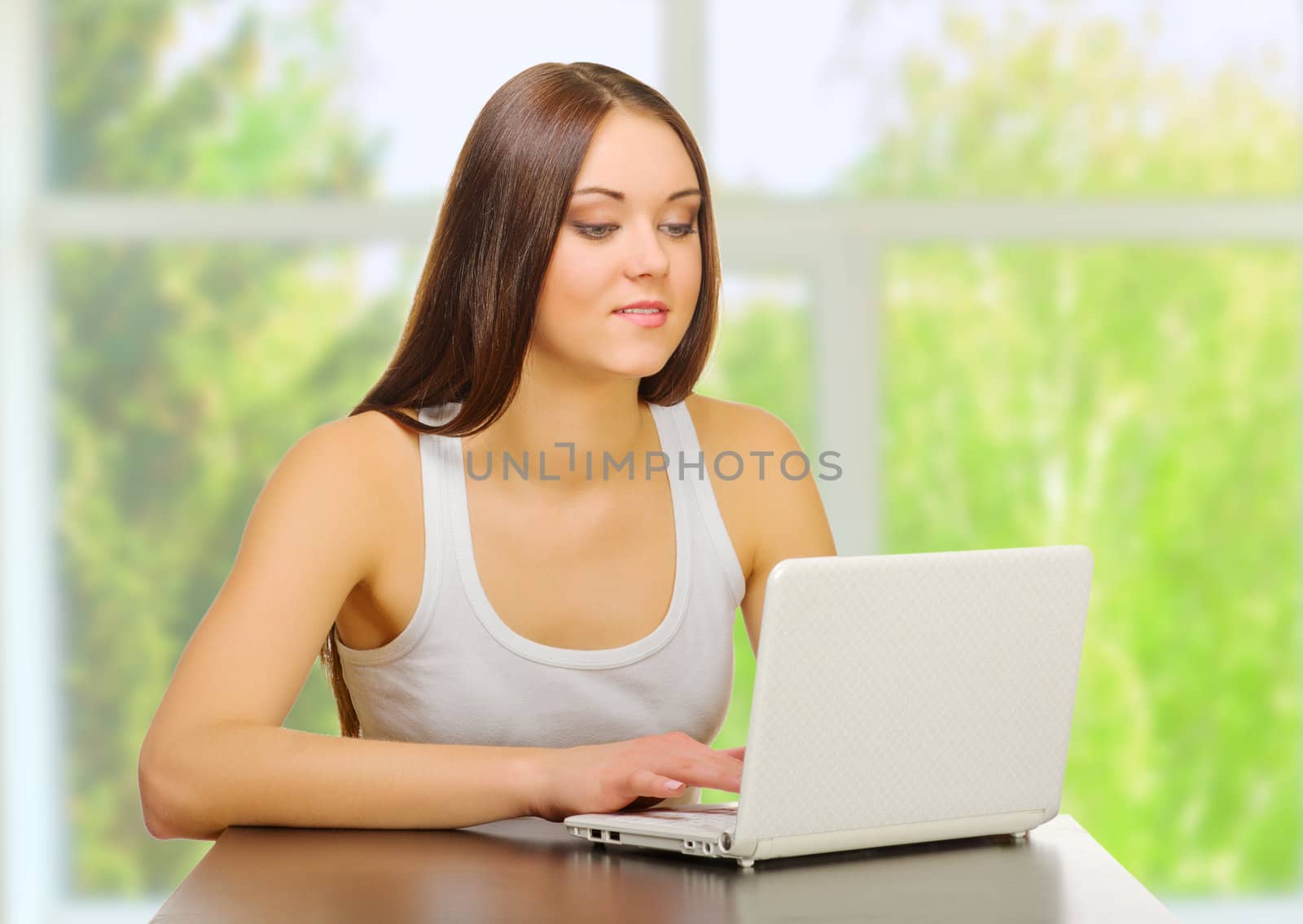 Young girl with laptop at home