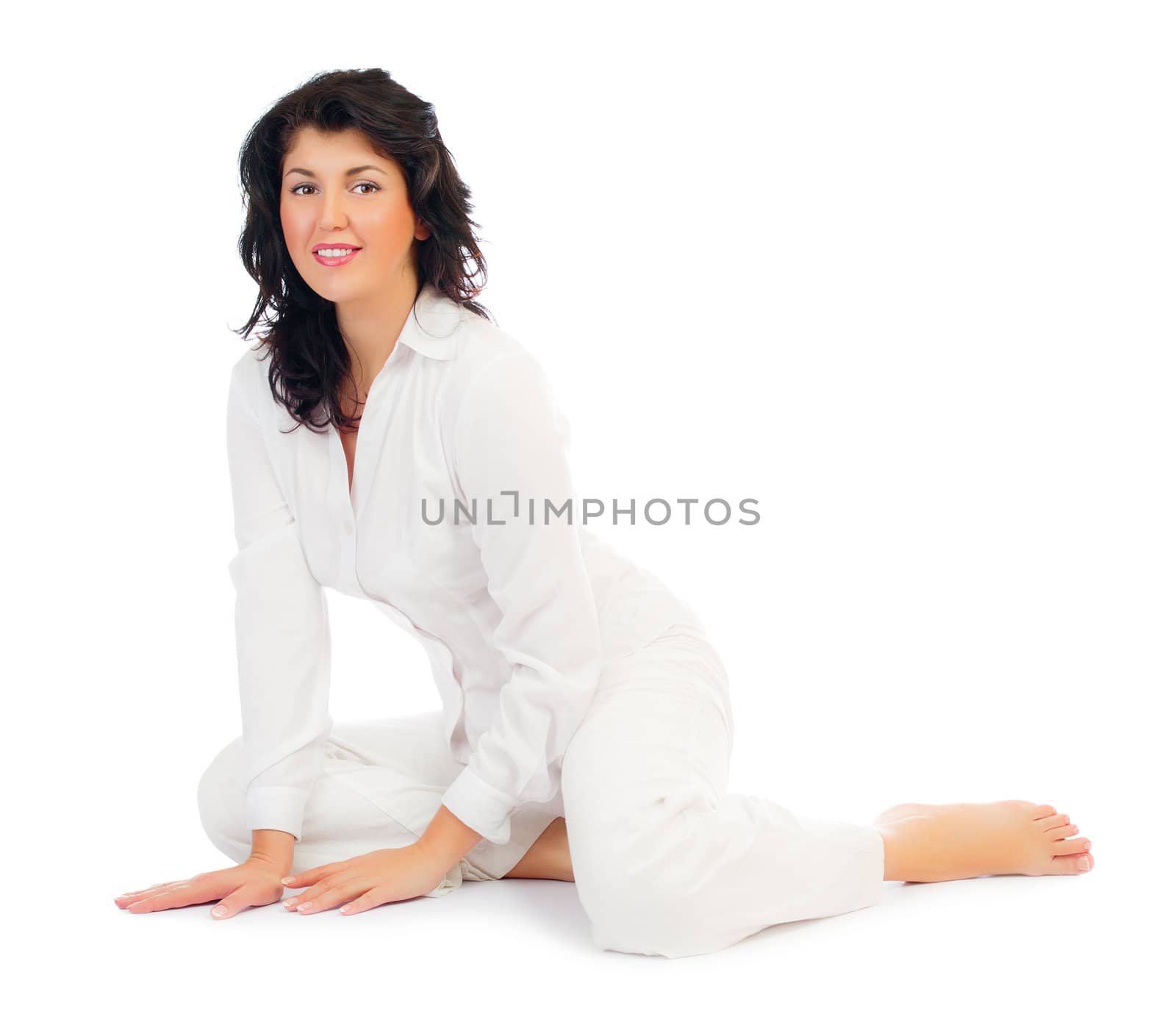 Young smiling woman sitting on floor isolated