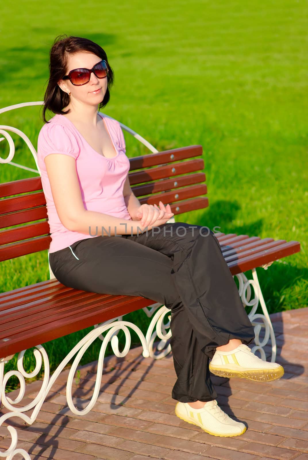 Young smiling woman on a bench